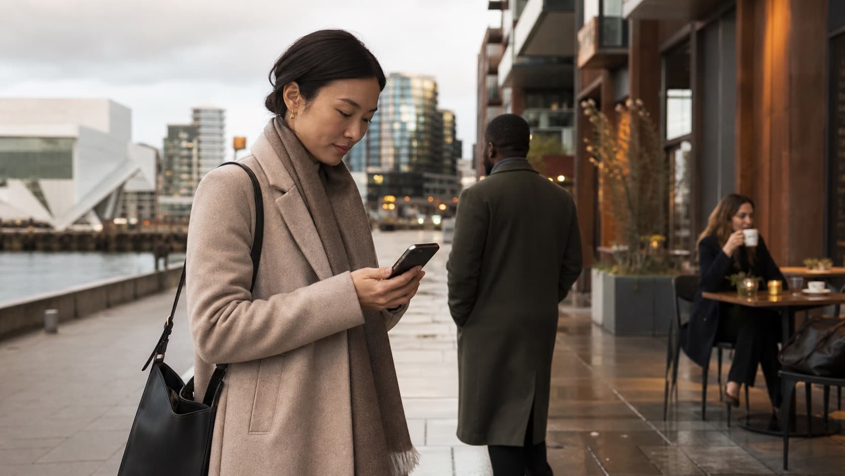 Guest using a private guest experience on a phone by an urban waterfront